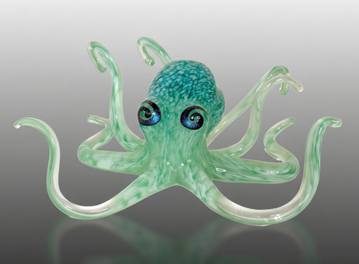 Glass octopus figurine on gray background