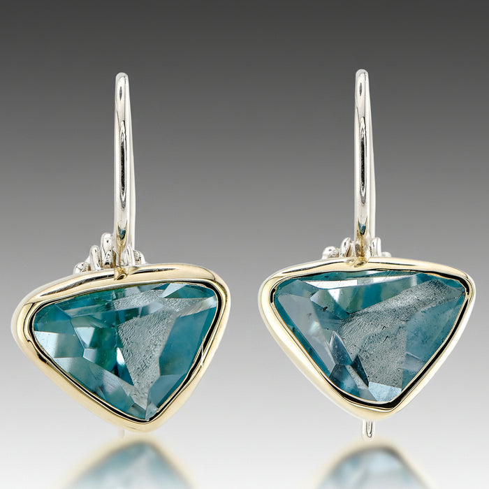 A pair of aquamarine earrings set in 18k yellow gold with sterling silver wires.