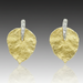 Gold leaf-shaped earrings with diamond accents on a gray background