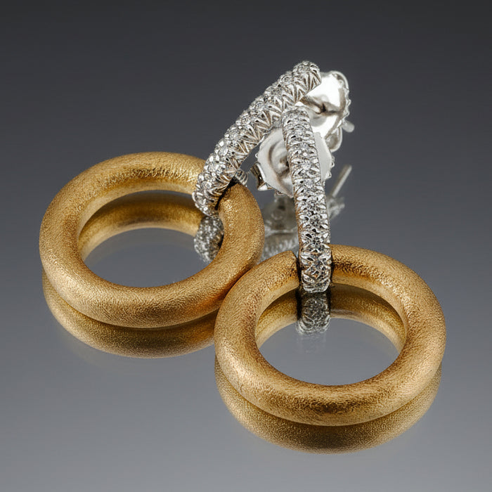 A pair of diamond bar earrings with 18k white gold bars and 18k yellow gold hoops, featuring multiple diamonds set along the bars.