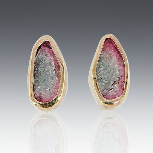 A pair of bi-color tourmaline stud earrings set in 18k yellow gold with sterling silver posts.