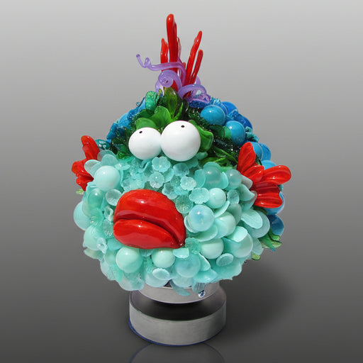 Colorful sculpture resembling a character with a round base on a gray background