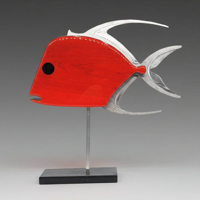 A cherry red lookdown fish sculpture with a high-gloss red resin coated face, silver aluminum fins, and a waterborne black lacquer on the sides and back, displayed on a metal stand.