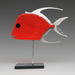 A cherry red lookdown fish sculpture with a high-gloss red resin coated face, silver aluminum fins, and a waterborne black lacquer on the sides and back, displayed on a metal stand.