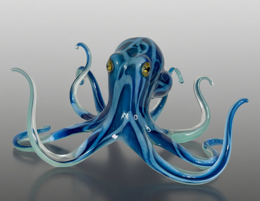 Blue glass octopus on a gray background