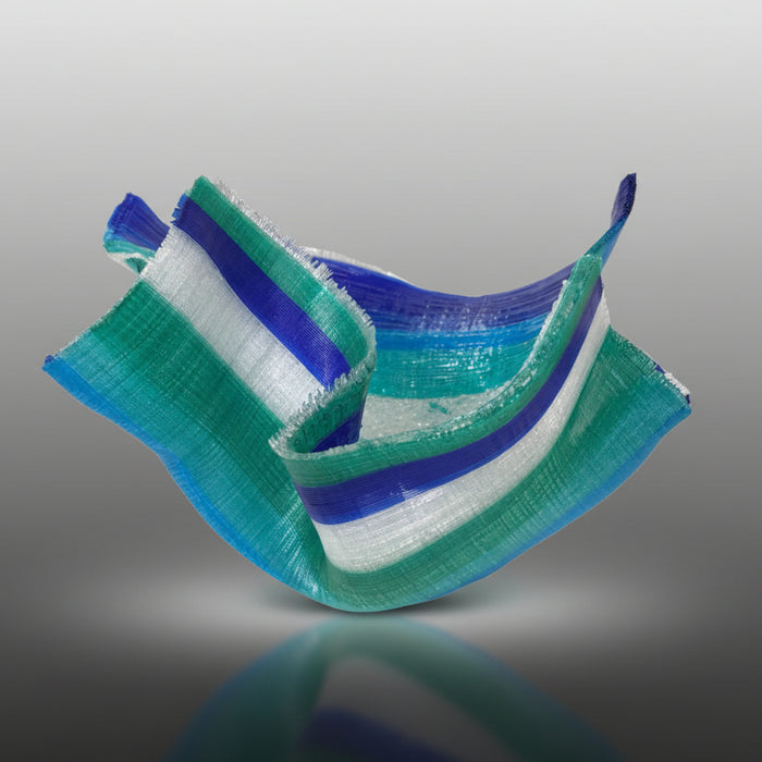 Stack of green, blue, and white striped ribbons on a gray background