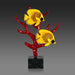Decorative sculpture of two yellow fish on red coral with a black base against a gray background