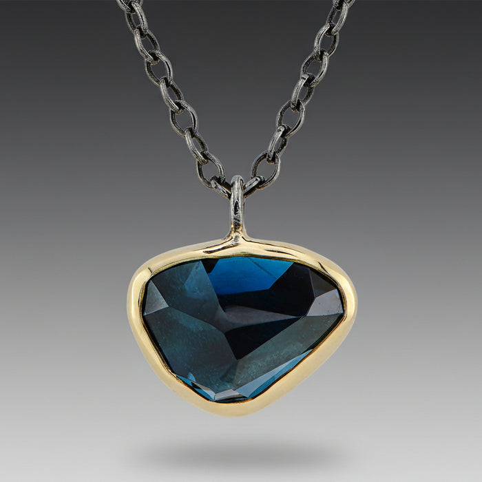 London Blue Topaz necklace with 18k yellow gold settings on a chain, oxidized sterling silver chain with bar accents.