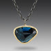 London Blue Topaz necklace with 18k yellow gold settings on a chain, oxidized sterling silver chain with bar accents.