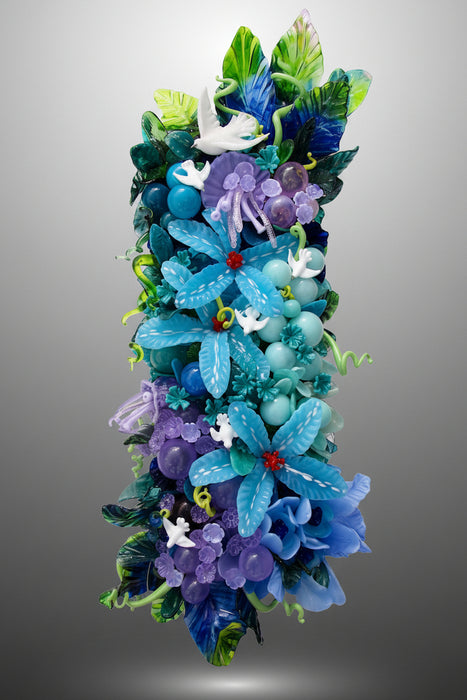A handmade wall lamp featuring a design with glass flowers, bubbles, and doves in various shades of blue, pink, and green, with white peace doves.