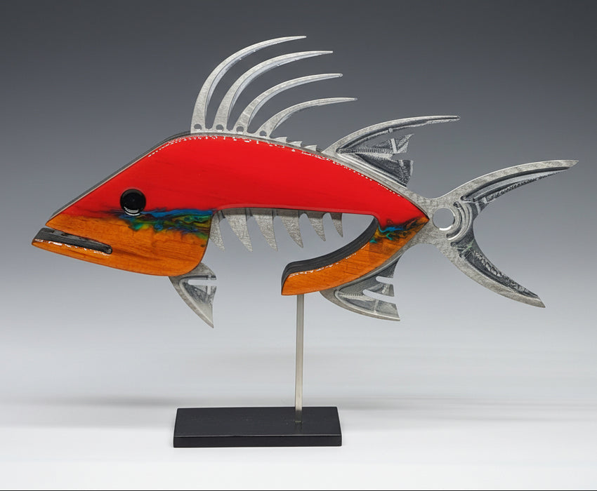 A mixed media wall sculpture of a red hogfish with accents in silver and gold, featuring a coral reef-inspired stripe and crafted from materials including soft maple, aluminum, and epoxy.