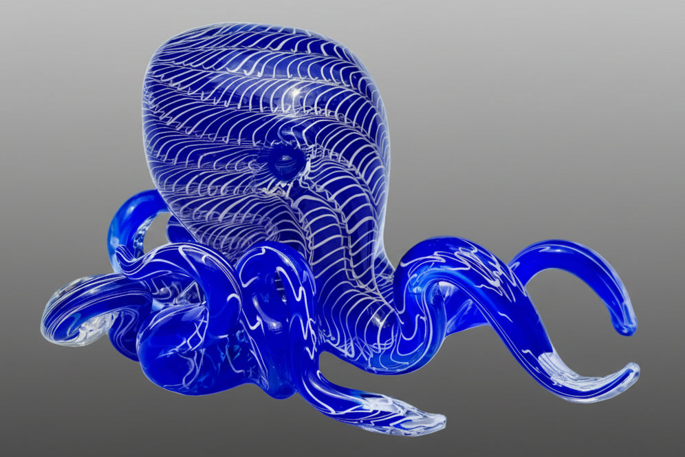 Blue glass octopus sculpture on a gray background