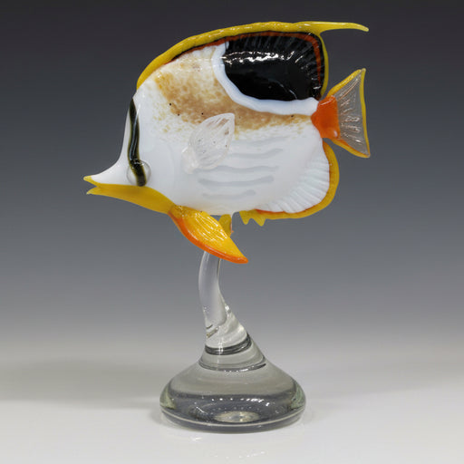 Glass wine glass with a fish design on a white surface