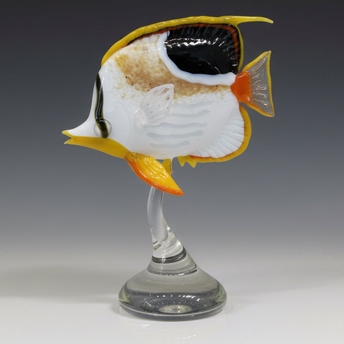 Glass wine glass with a fish design on a white surface