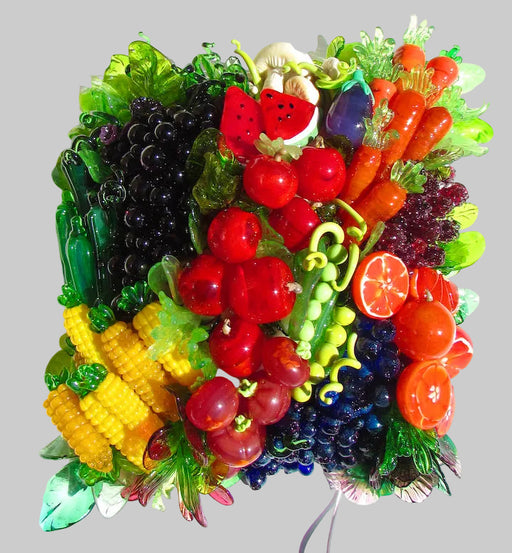 A wall-mounted Veggie Wall Light featuring a colorful arrangement of fruit and vegetable-shaped glass pieces, with a variety of colors and textures.