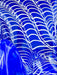 Blue glass sculpture with wavy patterns