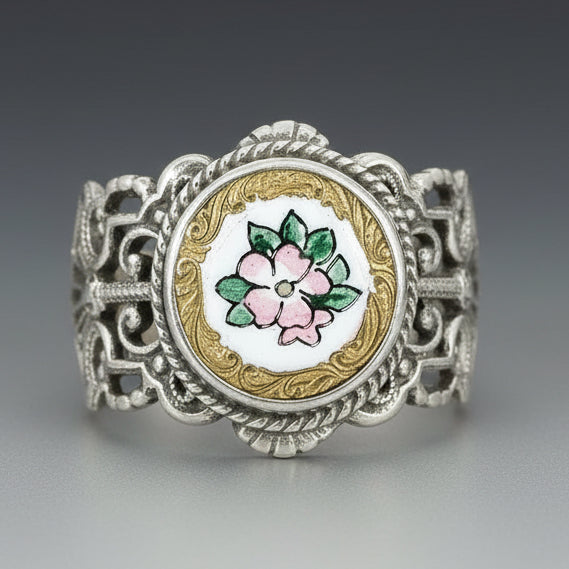 A Victorian French Enamel Flower Button Ring with a sterling silver band and a multicolored floral design on the button.