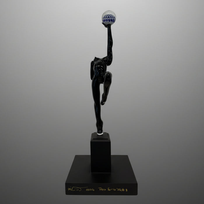 Black sculpture of a dancer on a gray background 