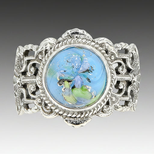 A sky blue Leo Popper glass button ring set in sterling silver with intricate filigree work, displayed against a white background.