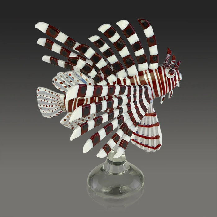 Decorative glass sculpture of a lionfish on a gray background