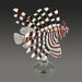 Decorative glass sculpture of a lionfish on a gray background
