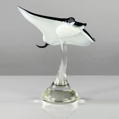 Glass manta ray sculpture on a white background