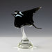 Glass sculpture of a manta ray on a white background