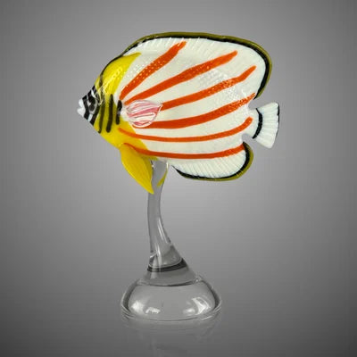 Decorative fish figure on a stand against a gray background