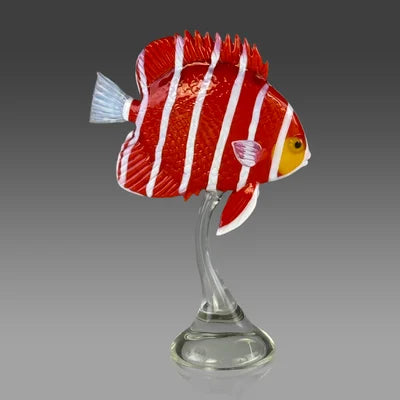 Red and white fish figurine on a clear stand against a gray background