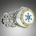 A Victorian Nautical Glass Button Ring with a white and blue glass center, surrounded by a metallic border with intricate detailing, set in a sterling silver band.