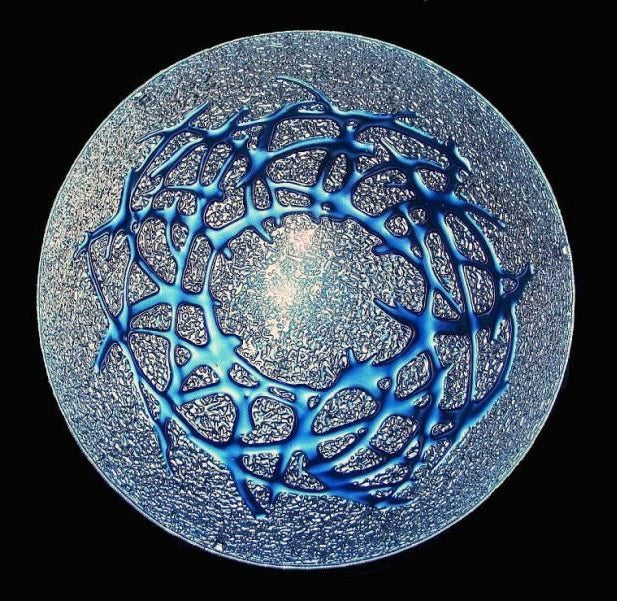 Spherical structure with blue network-like pattern on a black background