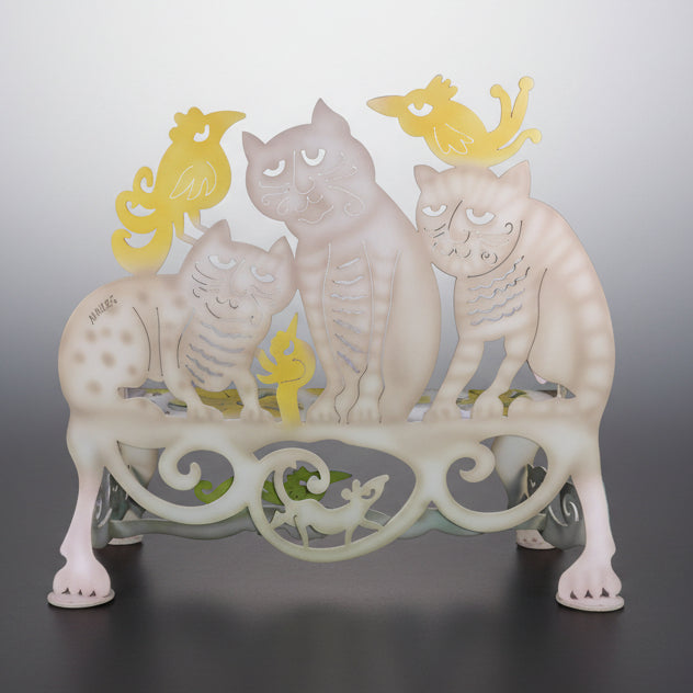 Decorative metal stand with cat designs on a gradient background