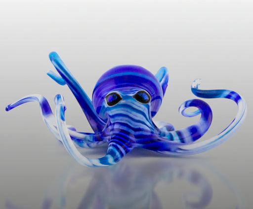 A blown glass sculpture of a blue and aqua octopus.