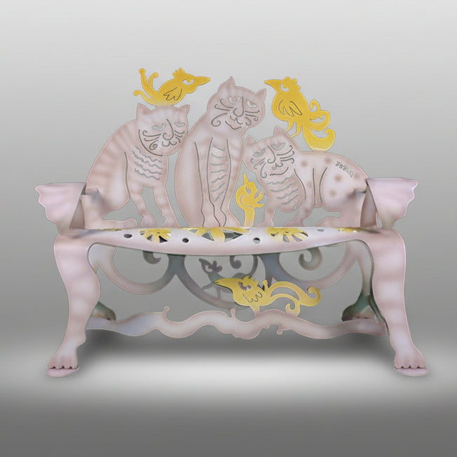 A metal cat-themed bench with cats in various colors and poses decorating the seat and back.