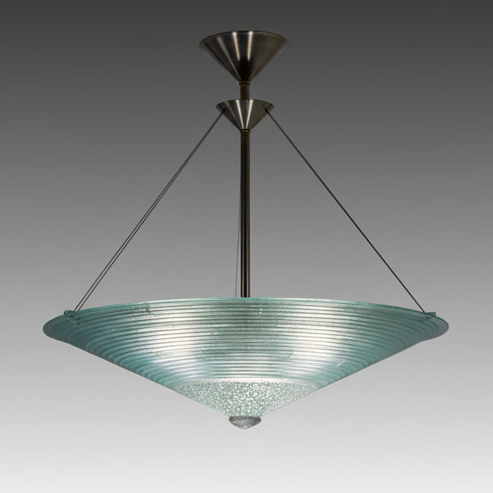 A Concentric Circles glass chandelier with a large, round, textured glass bottom and a smaller, rod-like structure at the top, suspended by metal cables.