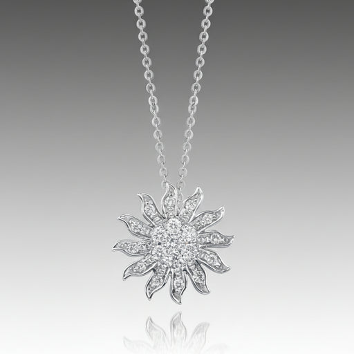 A silver pendant necklace with a graffiti sun icon design, featuring a round, brilliant cut diamond in a pave setting.
