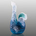 Blue glass sculpture with textured surface on a gray background