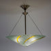 A round chandelier with clear glass and gold accents, suspended by metal cables.