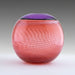 A round salmon pink blown glass vase with a white cane spiral pattern and a purple Incalmo rim.