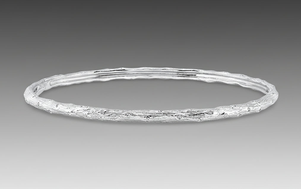 A textured gold bracelet with a solid pattern, likely made from 18k white gold as part of Aaron Henry's Signature Arbor Collection.