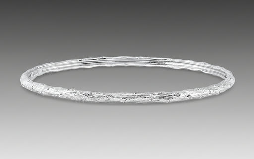 A textured gold bracelet with a solid pattern, likely made from 18k white gold as part of Aaron Henry's Signature Arbor Collection.